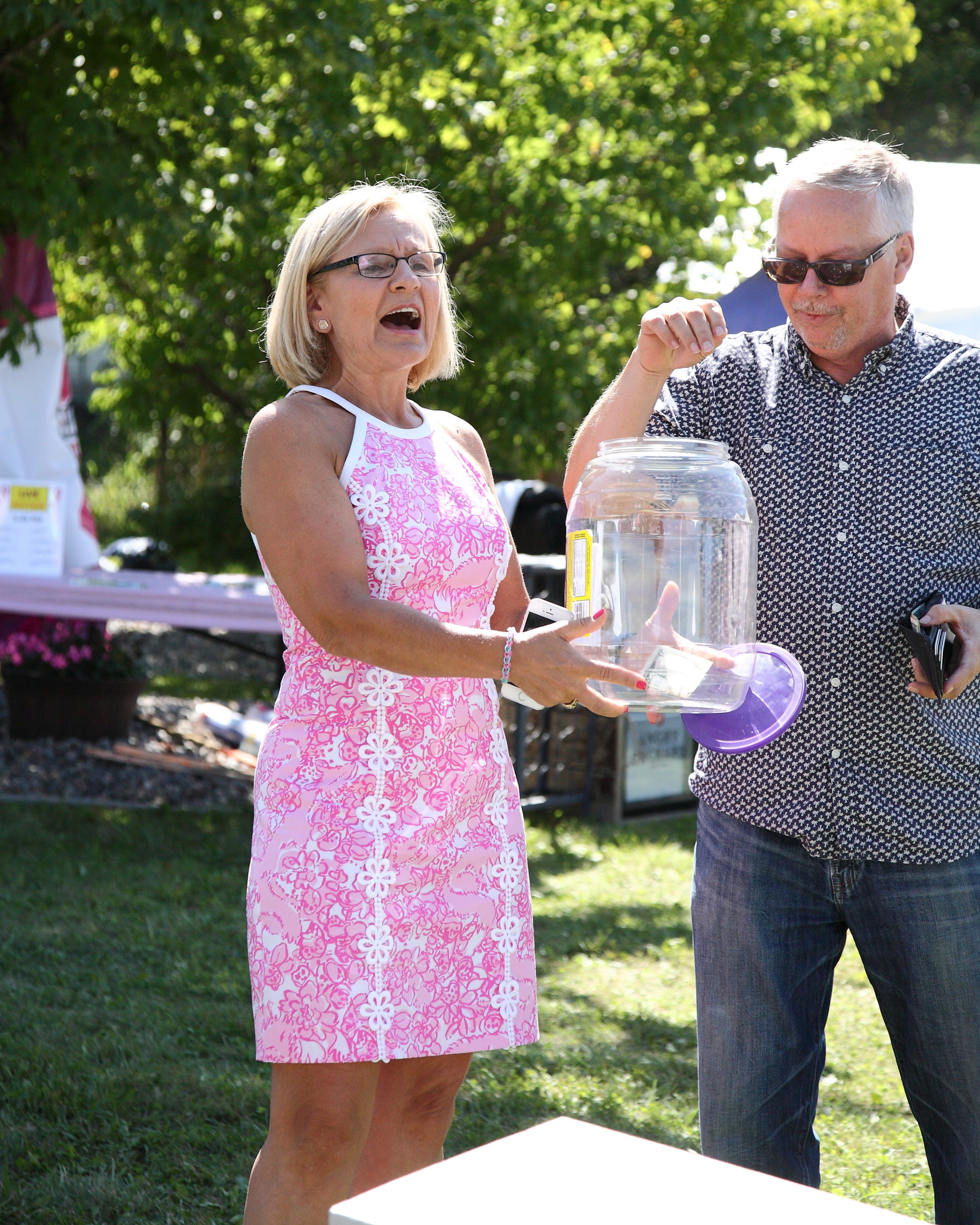 Judy holding a jar full of money with Peter dropping money in